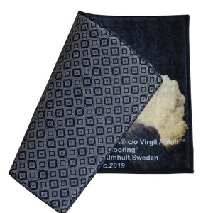 Pu&ograve; includere: Un tappeto con motivo a scacchi bianco e nero con un design di nuvola beige e bianco. Il tappeto ha il testo "c/o Virgil Abloh&trade;" e "Flooring" stampato su di esso. Il testo "almhult, Sweden" e "c.2019" &egrave; anche stampato sul tappeto.