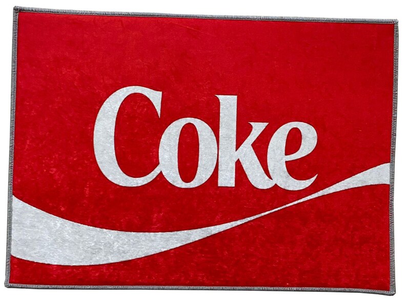 May include: Red doormat with a white wave design and the word "Coke" in white lettering.