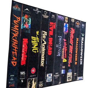 May include: A collection of VHS tapes featuring horror movie titles like "Halloween", "Friday the 13th", "A Nightmare on Elm Street", "Re-Animator", "Evil Dead", "Phantasm", and "The Thing".