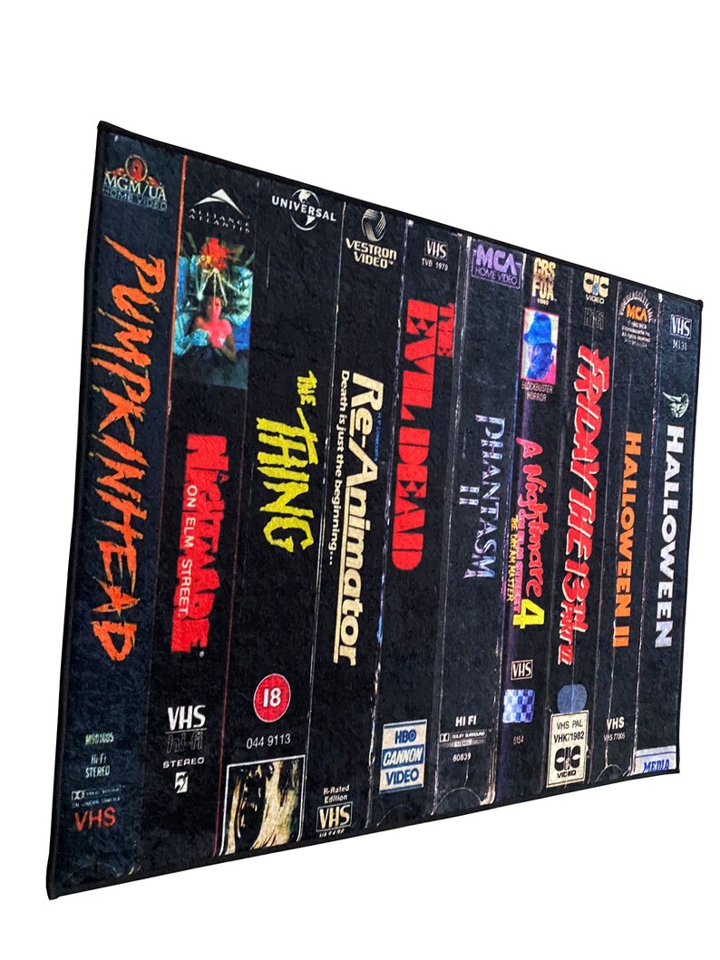 May include: A collection of VHS tapes featuring horror movie titles like "Halloween", "Friday the 13th", "A Nightmare on Elm Street", "Re-Animator", "Evil Dead", "Phantasm", and "The Thing".