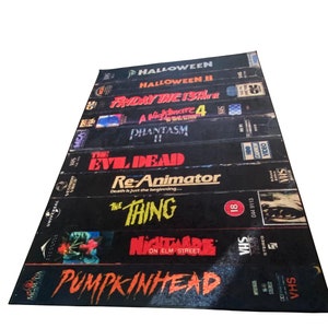 May include: A stack of VHS tapes featuring horror movie titles including Halloween, Friday the 13th, A Nightmare on Elm Street, and The Thing.