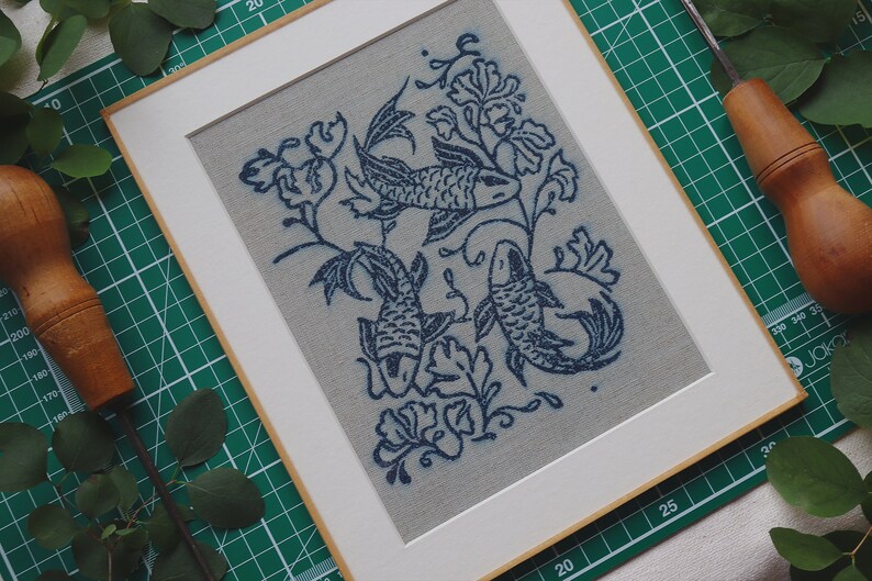 Linocut art print in indigo ink on natural irish linen featuring swimming koi fish and William Morris inspired botanical designs. Framed in a frame package. 8x10 inches.