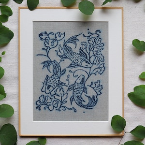 Linocut art print in indigo ink on natural irish linen featuring swimming koi fish and William Morris inspired botanical designs. Framed in a frame package. 8x10 inches.