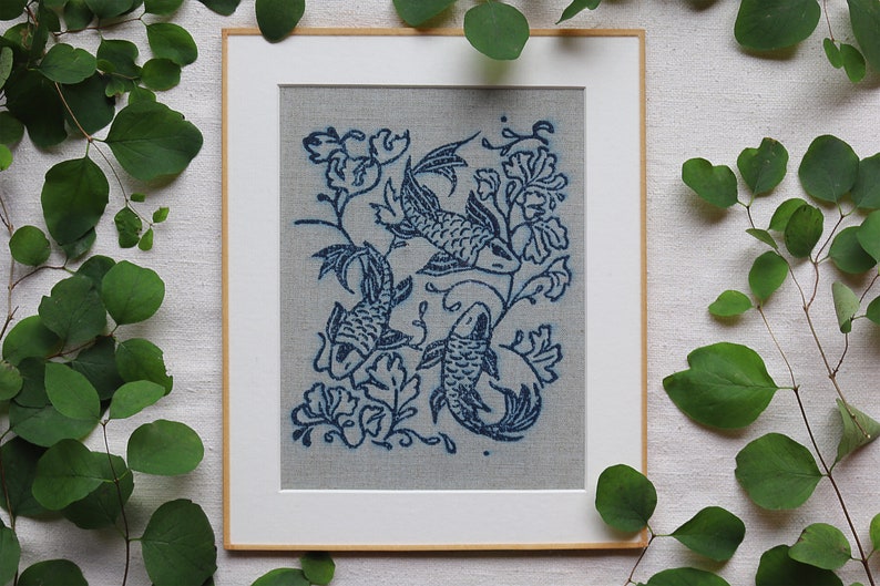 Linocut art print in indigo ink on natural irish linen featuring swimming koi fish and William Morris inspired botanical designs. Framed in a frame package. 8x10 inches.