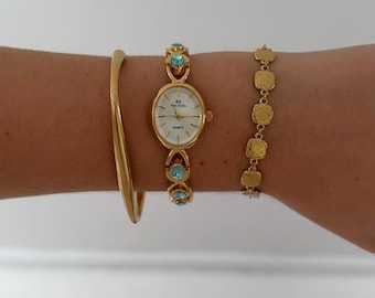 Reloj ovalado chapado en oro vintage, pulsera con gema azul, reloj de pulsera de esfera pequeña.