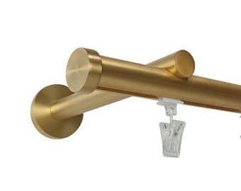 May include: Gold metal curtain rod with clear plastic curtain clips. The rod is designed for a corner window and has a round end cap.