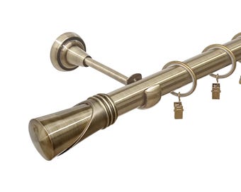 May include: A brushed antique brass curtain rod with finials and rings. The rod is mounted to the wall with a bracket.