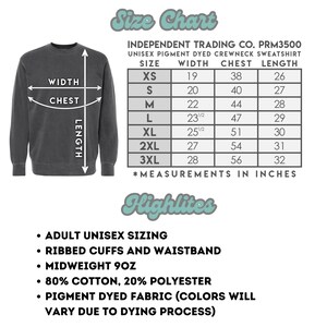 May include: Size chart for a unisex pigment dyed crewneck sweatshirt. The chart shows measurements in inches for width, chest, and length for sizes XS to 3XL. The sweatshirt is made of 80% cotton and 20% polyester.