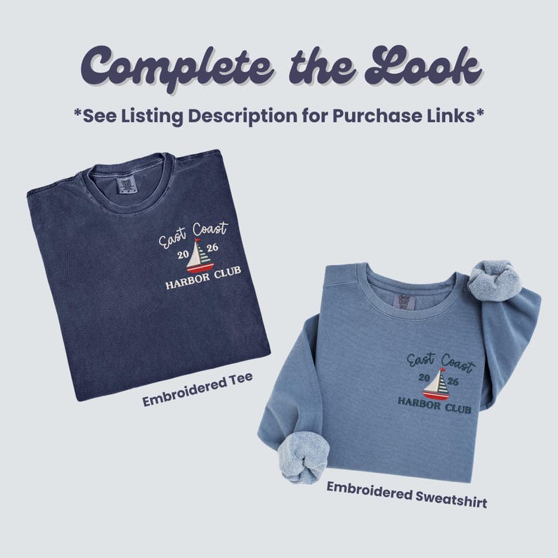 May include: Two embroidered shirts. A navy blue tee and a light blue sweatshirt, both with the text "East Coast 2026 Harbor Club" and a sailboat design. The sweatshirt has rolled-up sleeves.