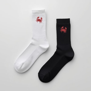 May include: A pair of crew socks, one white and one black, each featuring a red crab design near the cuff. The socks are made of a soft material and are suitable for everyday wear.