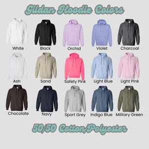 May include: Image showcasing a variety of Gildan hoodie colors. The image displays hoodies in shades like white, black, orchid, violet, charcoal, ash, sand, safety pink, light blue, light pink, chocolate, navy, sport grey, indigo blue, and military green. The hoodies are made of 50/50 cotton/polyester.