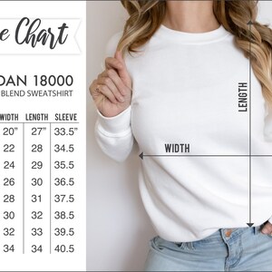 May include: Size chart for Gildan 18000 heavy blend sweatshirt. The chart shows measurements in inches for size, width, length, and sleeve. Sizes range from S to 5XL.