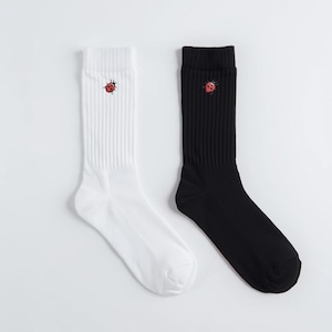 May include: A pair of ribbed crew socks, one white and one black, each featuring a small embroidered red ladybug near the cuff. The socks are displayed on a white background.