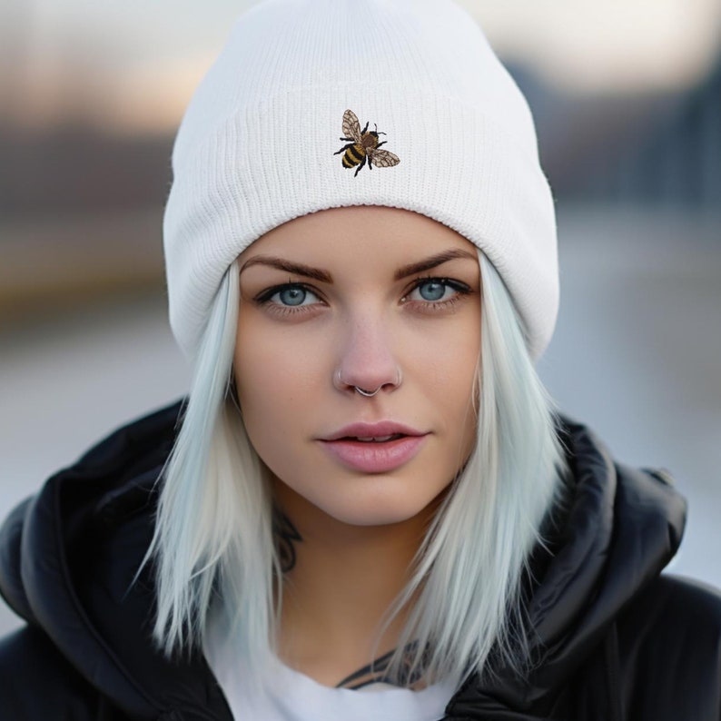 White knit beanie hat with an embroidered mini honey bee on the cuff of the hat.