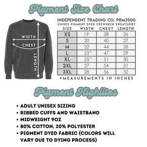 May include: A dark gray unisex pigment-dyed crewneck sweatshirt with a size chart and product details. The chart lists sizes XS to 3XL with measurements in inches for width, chest, and length. Features include ribbed cuffs, waistband, and midweight 9oz fabric.