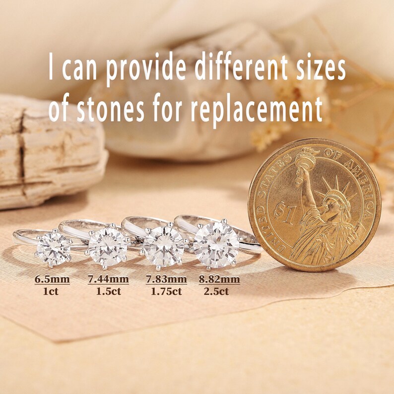 May include: Four silver rings with clear, round gemstones of varying sizes are displayed next to a US dollar coin. The text on the image reads, "I can provide different sizes of stones for replacement." The gemstones range from 6.5mm to 8.82mm.