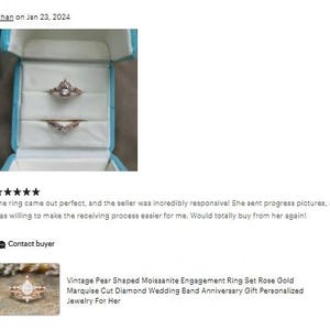 May include: A rose gold engagement ring set in a light blue ring box. The set includes a pear-shaped moissanite engagement ring and a marquise cut diamond wedding band. The ring is a vintage style.