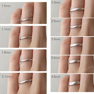 May include: A collection of silver-toned metal rings with a matte finish, displayed in a series of eight variations. Each ring is labeled with its specific width, ranging from 1.5mm to 4.0mm, providing a clear visual comparison of the band thicknesses.