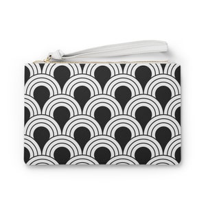 May include: A black and white geometric pattern clutch bag with a white zipper and a white strap.