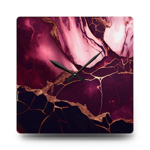 May include: Square wall clock with a burgundy and pink marble design with gold accents. The clock face is black with black hands.