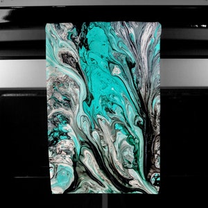 May include: Abstract art print featuring swirling patterns in shades of teal, black, white, and grey.