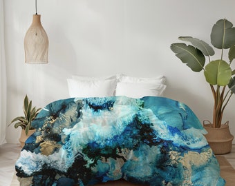 May include: A blue and gold abstract print duvet cover with a white background. The duvet cover is on a bed with white pillows.
