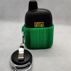 May include: A black and green vape case with a black retractable keychain. The case has the word "FLYM" printed on it in gold letters.