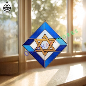 May include: Stained glass window art featuring a Star of David design. The artwork is set within a blue and white diamond shape, with a gold star at the center. The piece is designed to hang, with the text "ONIONARTWORKS" visible.