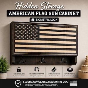 May include: A wall-mounted wooden gun cabinet featuring a dark-stained American flag design on the front panel. The unit includes three black metal hooks underneath, a biometric lock, magnetic gun mount, soft-close hinges, and hidden storage.