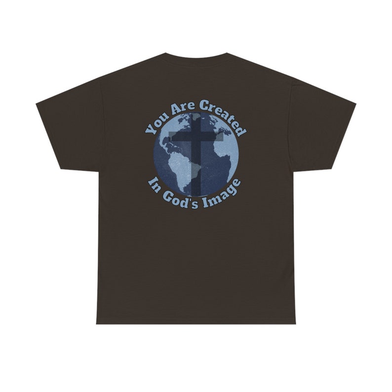 May include: A brown t-shirt with a blue and white graphic of a cross over a globe. The graphic says "You Are Created In God's Image".