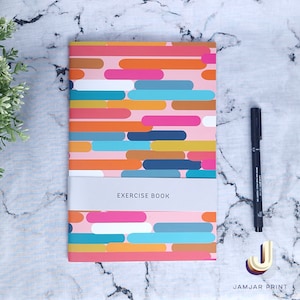 May include: A pink exercise book with a colourful geometric pattern of overlapping rectangles and ovals. The text "EXERCISE BOOK" is printed on the front cover.