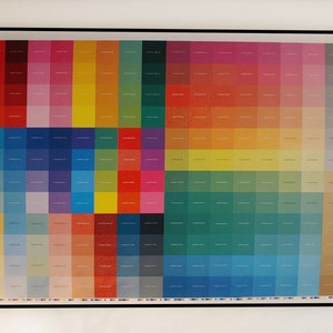 May include: A framed colour chart with a grid of small squares in various shades of red, orange, yellow, green, blue, purple, and grey.