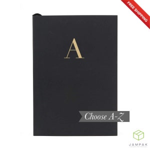 May include: Black notebook with a gold letter "A" on the front. The notebook has the text "Choose A-Z" on the bottom.