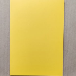 Puede incluir: Una hoja de papel amarilla lisa.
