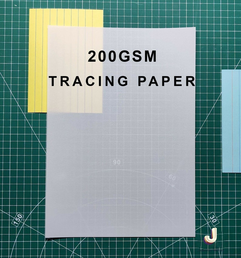 May include: A sheet of 200GSM tracing paper on a green cutting mat. The paper is translucent and has a grid pattern.