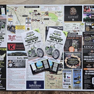 May include: A map and event guide for Sturgis, SD, featuring motorcycle-related businesses and attractions. The guide includes a map of downtown Sturgis, vendor information, and event details for August 1st-10th, 2025. The image also includes advertisements for helicopter tours and motorcycle audio.