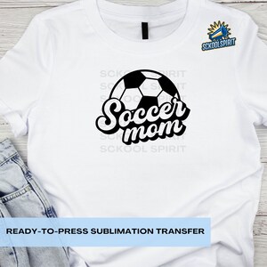 May include: White t-shirt with a black and white soccer ball and the text "Soccer mom" in a retro font.