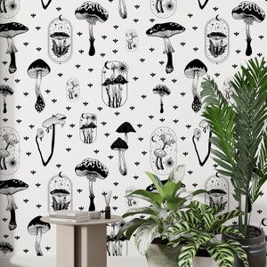 May include: Black and white wallpaper featuring a repeating pattern of mushrooms and celestial elements. The wallpaper is shown on a wall with a small table and two potted plants.