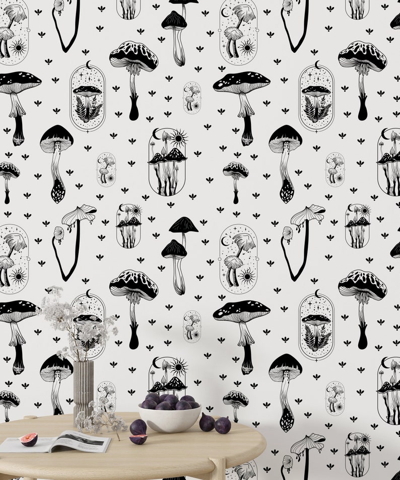 May include: Black and white wallpaper featuring a repeating pattern of mushrooms, stars, and moons. The mushrooms are of varying shapes and sizes, with some topped by a crescent moon. The background is a light grey.