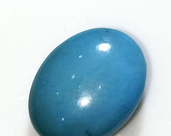 May include: A smooth, oval-shaped turquoise cabochon gemstone with a light blue colour.