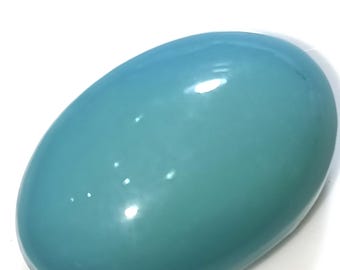 May include: A smooth, oval-shaped turquoise gemstone with a light blue colour.