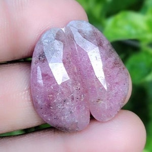 May include: Two pink and white gemstone cabochons with a faceted cut. The cabochons are heart-shaped and have a translucent appearance.