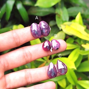 May include: Three pairs of faceted pink ruby gemstones in pear shapes. The gemstones are arranged in three rows, labeled A, B, and C.