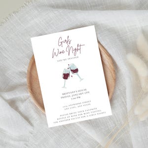 Ladies night "Girls Wine Night" invitation with white background, black font featuring two cheers-ing wine glasses. Minimalist design. Displayed as a printed invitation.