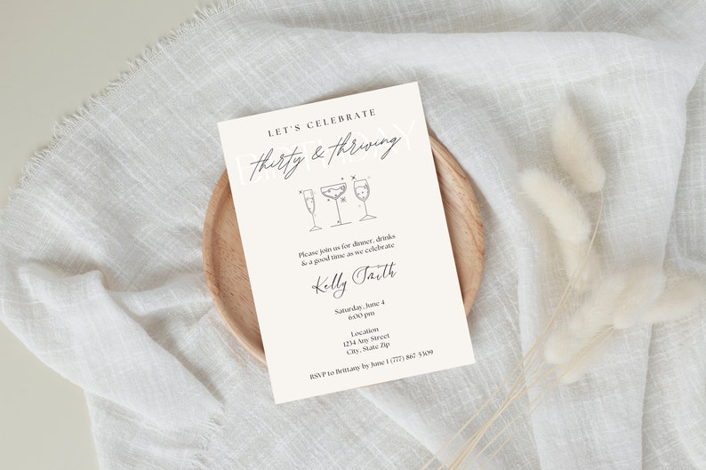 "Thirty and Thriving" birthday invitation with light pink background and black font featuring cocktails.