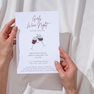 Ladies night "Girls Wine Night" invitation with white background, black font featuring two cheers-ing wine glasses. Minimalist design. Displayed as a printed invitation.