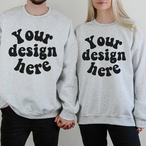 May include: Two gray sweatshirts with the text "Your design here" in black retro-style lettering.