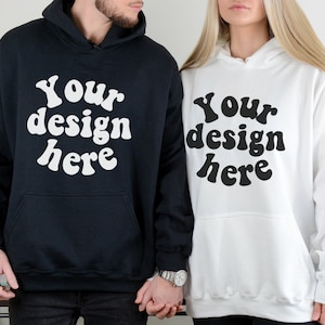 May include: Two hooded sweatshirts, one black and one white, with the text "Your design here" in a retro font.
