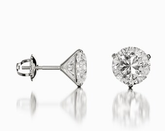 May include: A pair of silver stud earrings with a large, round, clear diamond in each earring.