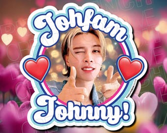 May include: A colorful sticker with a photo of a man with blonde hair and a blue shirt. The sticker has the text "Johfam" in a retro font and "Johnny!" in a similar font. There are two red hearts on either side of the photo.